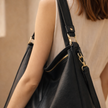 FJØRNA black vegan leather hobo shoulder bag with spacious design and attached pouch, stylish for women.