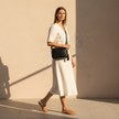 Black FJØRNA leather crossbody bag with Chevron strap, genuine leather, compact design for women.