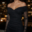 FJØRNA Ella women's black mini dress with sparkle mesh, size XS, featuring a stylish and fitted design for elegant occasions.