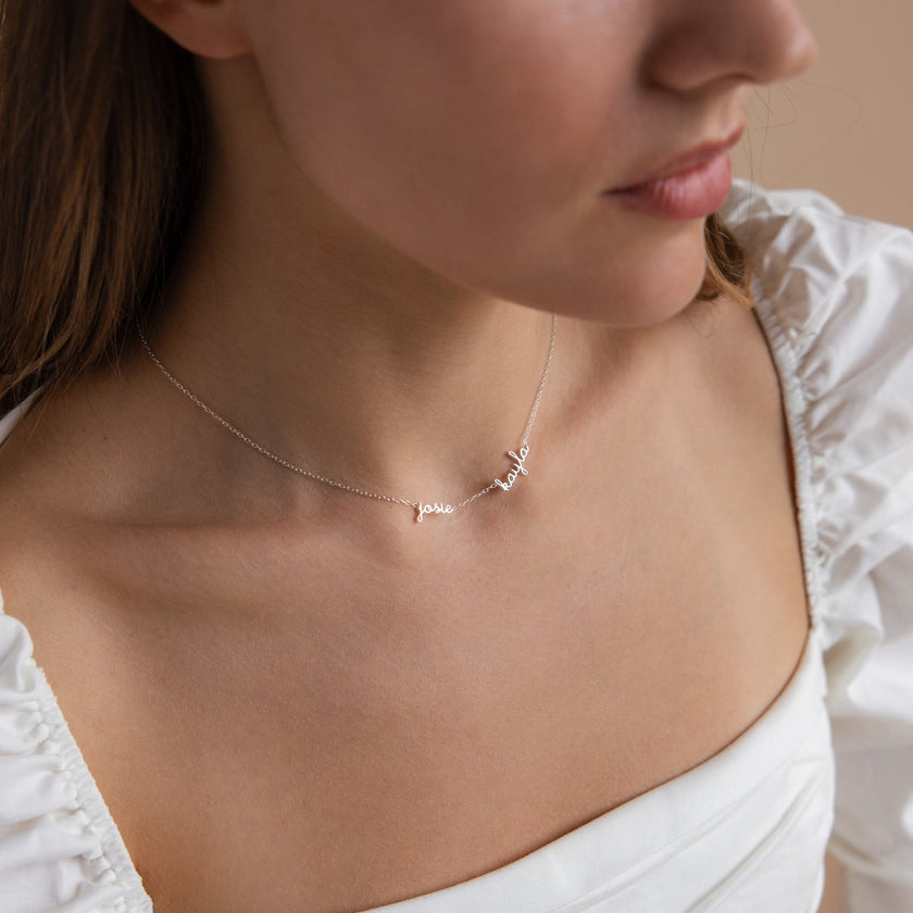 FJØRNA personalized gold unisex necklace with two or three custom names on a delicate 14-inch chain.
