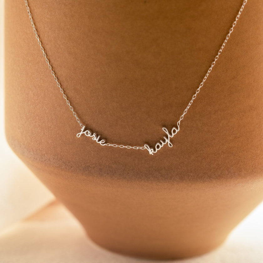 Dainty personalized gold unisex necklace with two names, featuring custom engraving, 14-inch length, by FJØRNA jewelry.