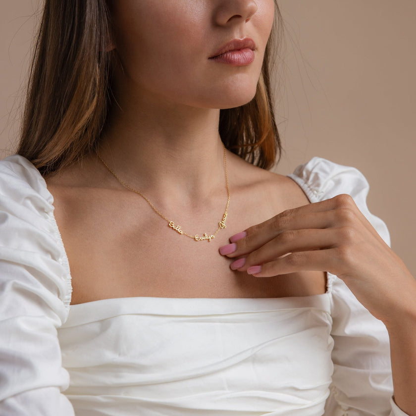Gold personalized unisex necklace by FJØRNA featuring two custom names on a delicate 14-inch chain.