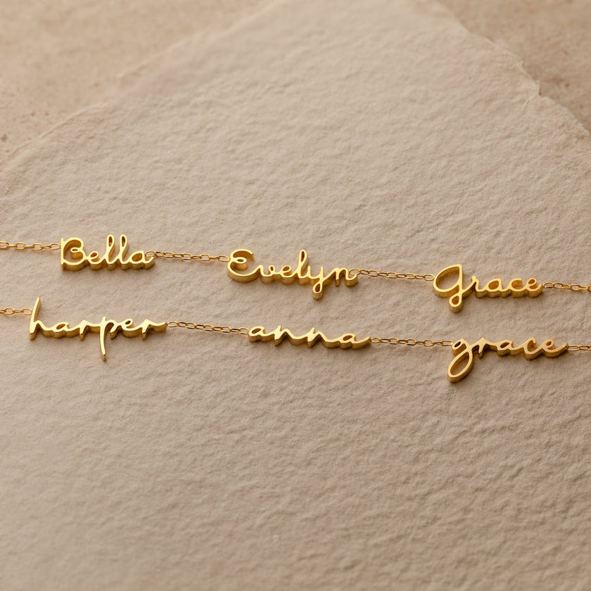 Personalised FJØRNA gold unisex necklace with two or three custom names, 14-inch dainty jewelry for men and women.