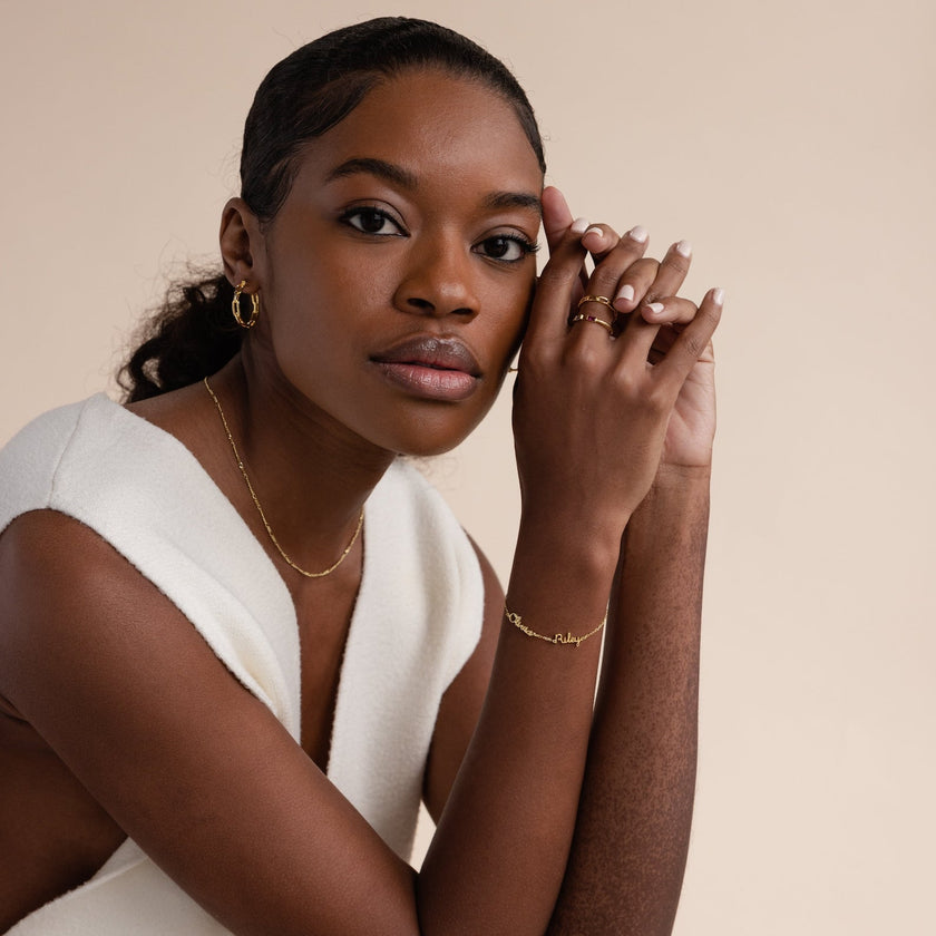 Gold personalized unisex ring by FJØRNA featuring engraved names, crafted in 18k gold or silver, designed for everyday wear.
