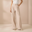 Beige high-waist wide-leg tailored pants for women by FJØRNA, showcasing a stylish and comfortable fit.