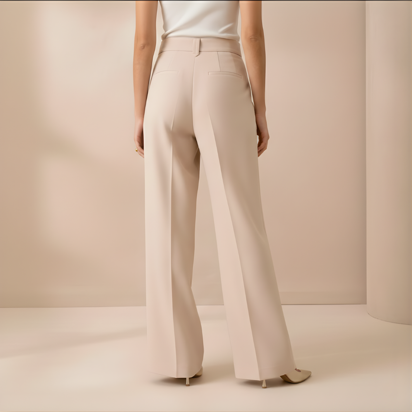 Beige high waist wide leg tailored women's pants by FJØRNA, showcasing a relaxed fit and elegant design.