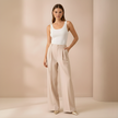 Beige FJØRNA wide leg high waist tailored pants for women, showcasing a relaxed fit and stylish design.