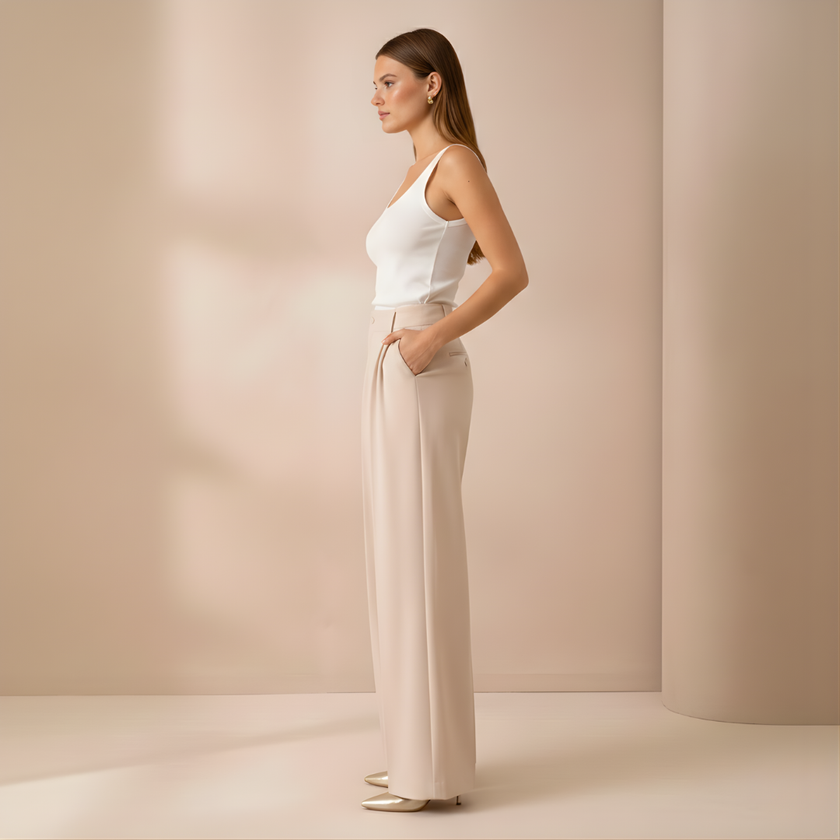 Beige high-waist wide-leg tailored pants for women by FJØRNA, featuring a relaxed fit and stylish design.