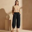 Black FJØRNA women's wide leg trousers with elastic waist, loose fit, cotton fabric, casual and comfortable for everyday wear.