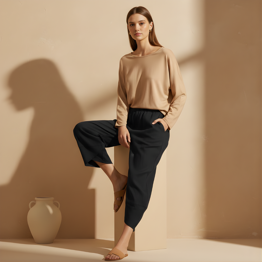 Black women's wide leg trousers with elastic waist from FJØRNA, loose fit, cotton fabric, perfect for casual and comfortable style.