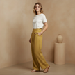 Yellow FJØRNA Liam women's high waist wide-leg cotton linen pants with pockets, featuring a plain color and relaxed fit.