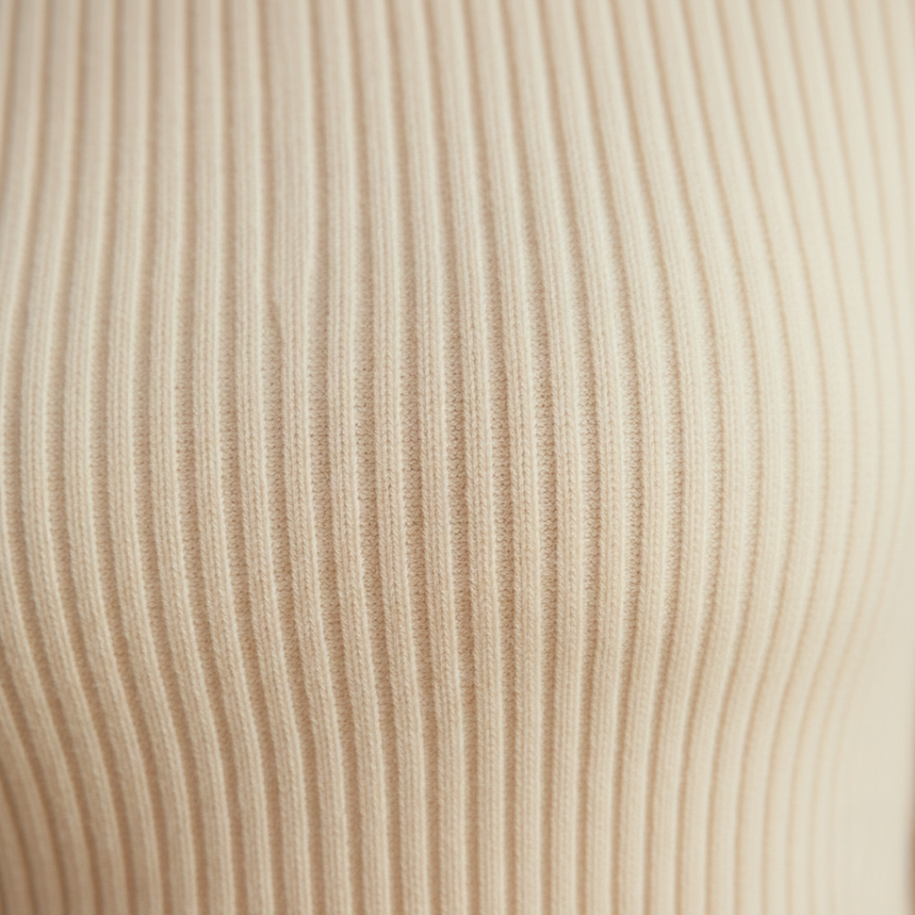 Beige FJØRNA long sleeve women's ruffle sweater, stylish knit top with a cozy fit and elegant design.