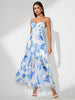 White midi dress by FJØRNA featuring floral pattern, spaghetti straps, ruffle hem, and slit, perfect for elegant summer wear.