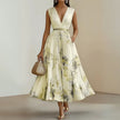Women's white printed V-neck sleeveless pleated dress by FJØRNA, showcasing a stylish and flowy design with a V-neck neckline.