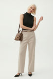 Women’s wool wide-leg trousers by FJØRNA featuring a high waist and tailored fit, showcased in a stylish outfit.