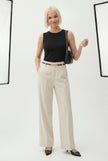FJØRNA women's wool wide-leg high-waist trousers displayed on a mannequin, showcasing a stylish and comfortable pant style.