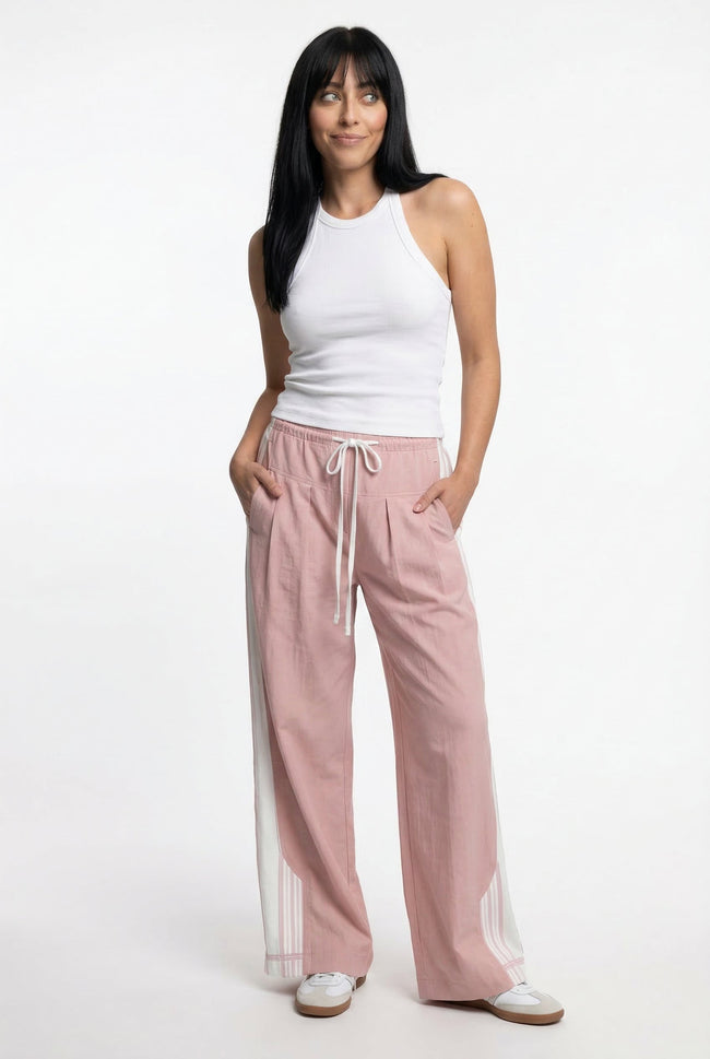 Women’s high waist cotton joggers by FJØRNA, elastic waistband and relaxed fit, shown on a person in a casual outfit.