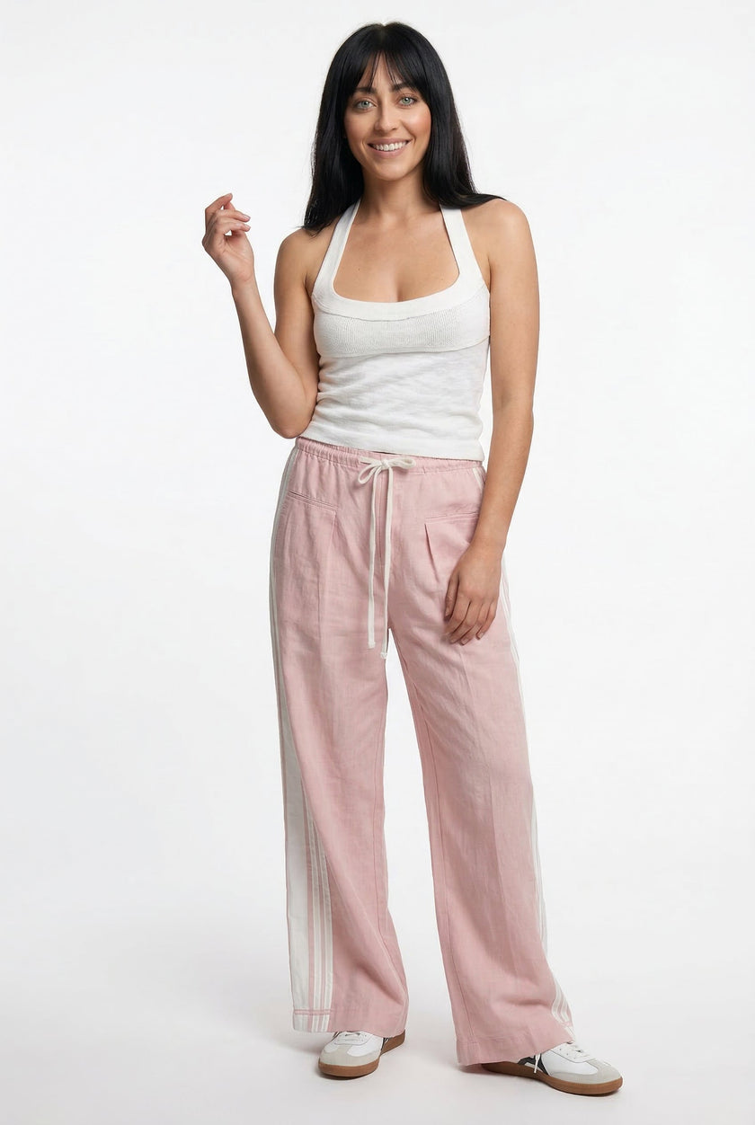 FJØRNA women's high-waist cotton joggers with elastic waistband, casual pants shown on a model in a relaxed outfit.