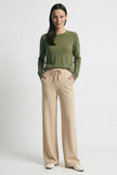 FJØRNA women's merino wool wide leg high waist trousers, showcasing the stylish and comfortable pants on a model.