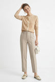 FJØRNA women's tapered wool trousers displayed on a model, showcasing a chic, tailored fit suitable for casual or professional wear.