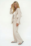 FJØRNA women's wide-leg high-waist trousers, stylish and comfortable pants with a relaxed fit, shown on a model.