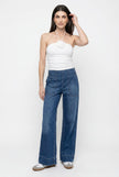 Women’s wide-leg denim jeans by FJØRNA, casual pants with a relaxed fit, shown in a natural pose.