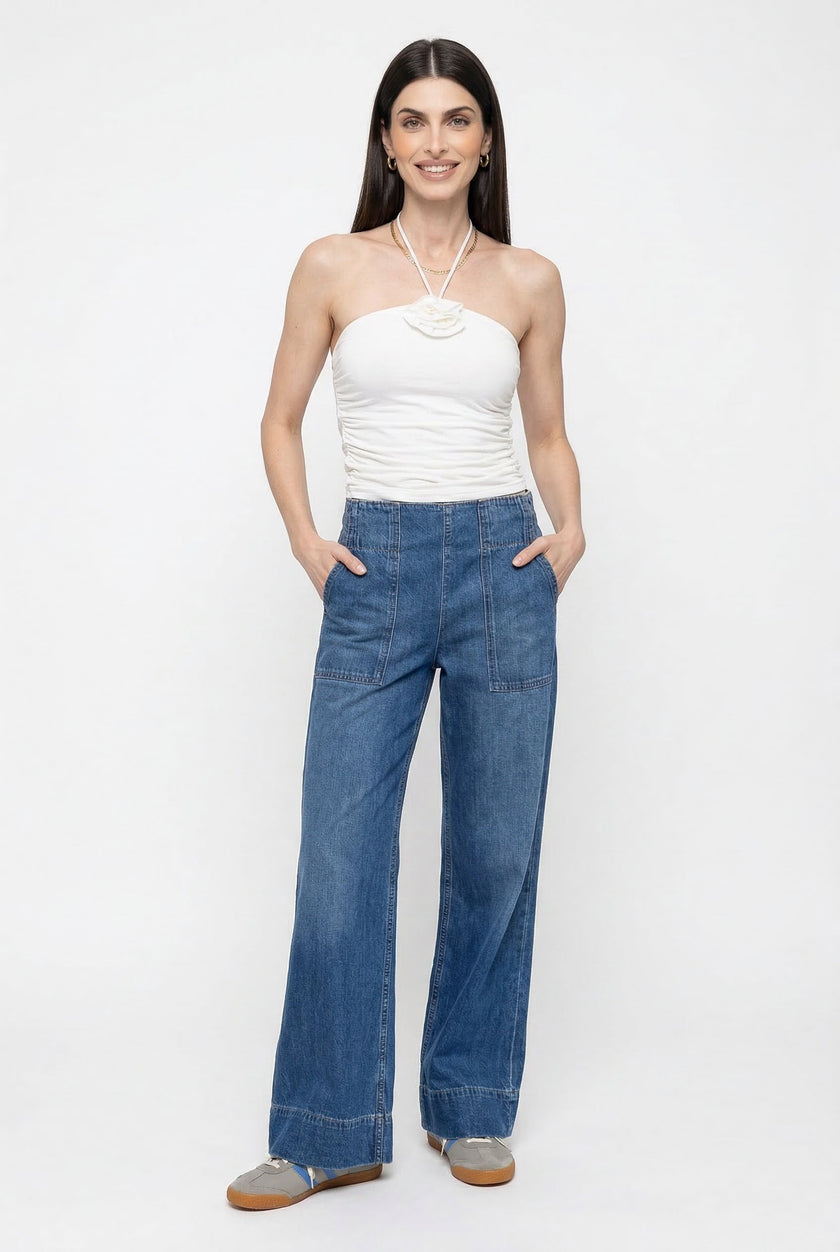 Women’s wide-leg denim jeans by FJØRNA, featuring a relaxed fit and classic blue wash, styled with casual footwear.