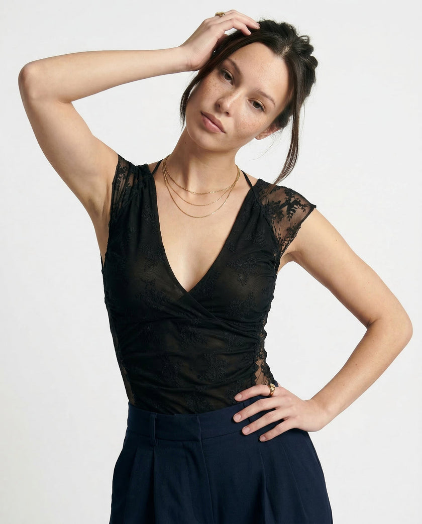 FJØRNA women's mesh top, lightweight and stylish, shown on a model, featuring a breathable, semi-sheer fabric with a modern design.