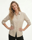 FJØRNA linen blouse for women, lightweight and breathable top with a relaxed fit, shown on a model.