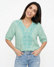 FJØRNA women's cotton V-neck blouse with long sleeves, featuring a relaxed fit and classic design, perfect for casual or office wear.