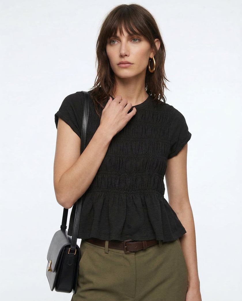 FJØRNA women's linen peplum blouse featuring a relaxed fit and stylish design, perfect for casual or office wear.