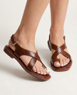 FJØRNA Italian leather women's sandals with adjustable straps, worn by a model showing their stylish design and white painted toes.