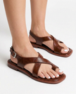FJØRNA Italian leather women's sandals with adjustable straps worn by a model, showcasing white-painted toes and stylish footwear.
