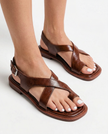 FJØRNA women's Italian leather sandals with adjustable straps, worn on a model's feet with white-painted toes.