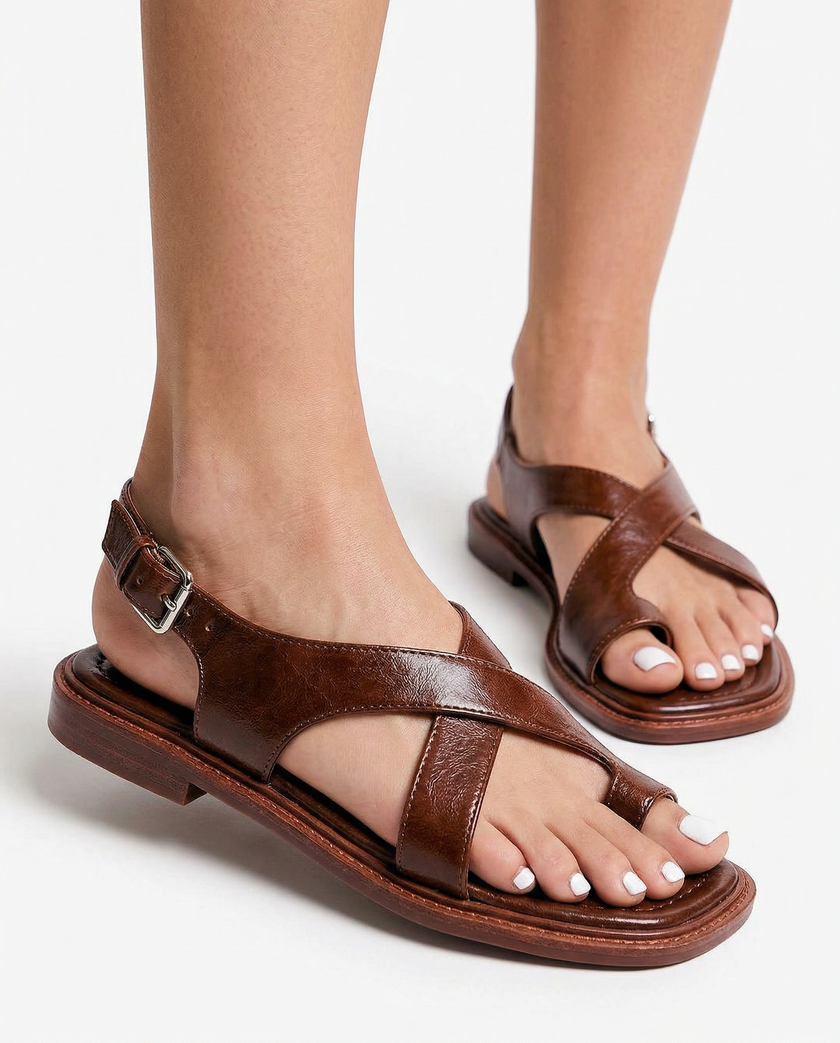 FJØRNA Italian leather women's sandals with adjustable strap, worn on model with white-painted toenails, showcasing stylish footwear.