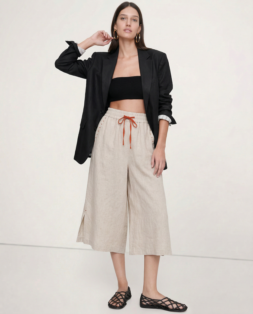 FJØRNA women's linen wide-leg trousers with drawstring, showing fabric texture and relaxed fit, casual stylish pants for women.