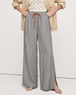 FJØRNA linen wide-leg women's trousers with drawstring, showcasing soft fabric and relaxed fit in a stylish pants design.