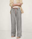 FJØRNA women's linen wide-leg trousers with drawstring, showcasing lightweight fabric and relaxed fit in a natural pose.