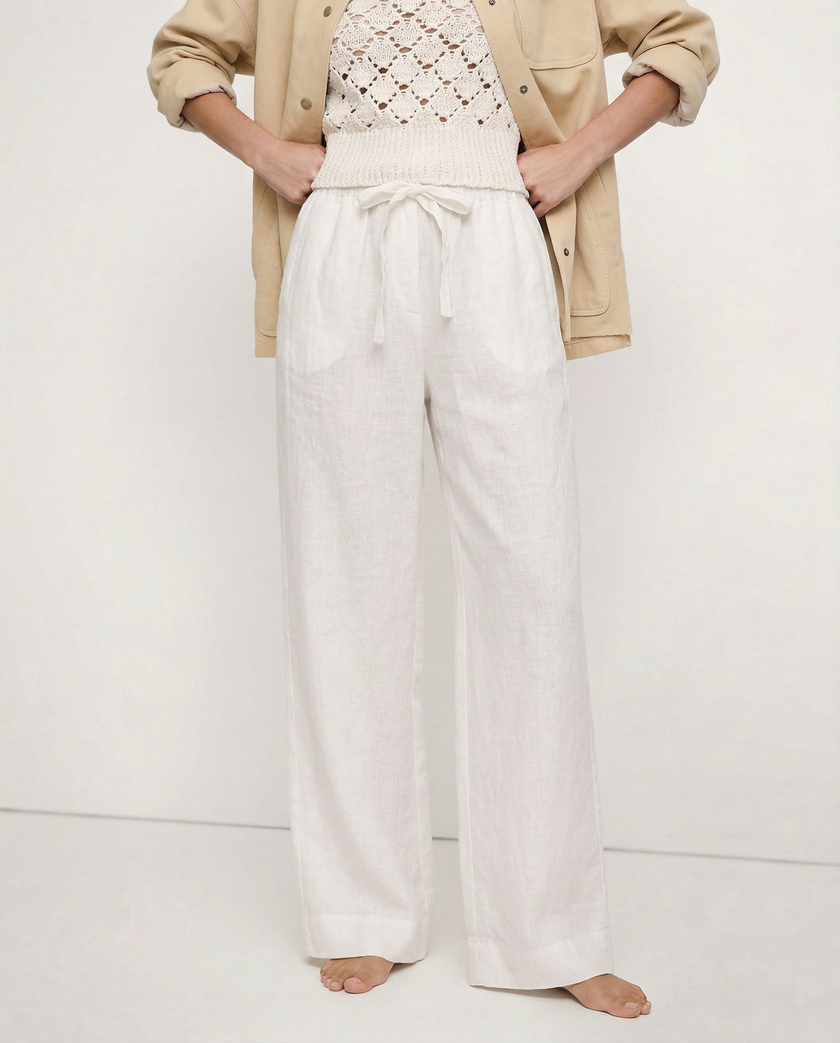 FJØRNA women's linen top with ruffle detail, showcasing lightweight fabric and stylish design for warm-weather wear.
