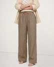 FJØRNA linen wide-leg women’s trousers with drawstring, showcasing lightweight fabric and relaxed fit style.
