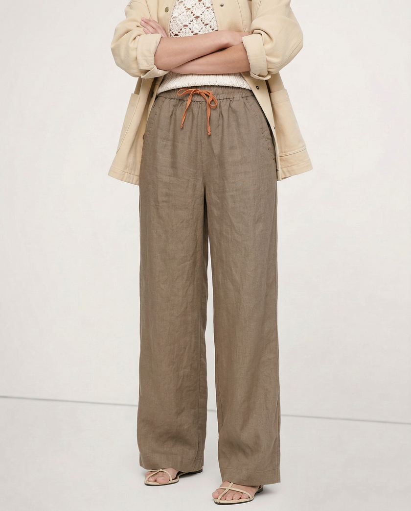 FJØRNA linen wide-leg women’s trousers with drawstring, showcasing lightweight fabric and relaxed fit style.