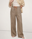 FJØRNA linen wide-leg trousers for women with drawstring waist, showcasing soft fabric and relaxed fit in a stylish casual look.