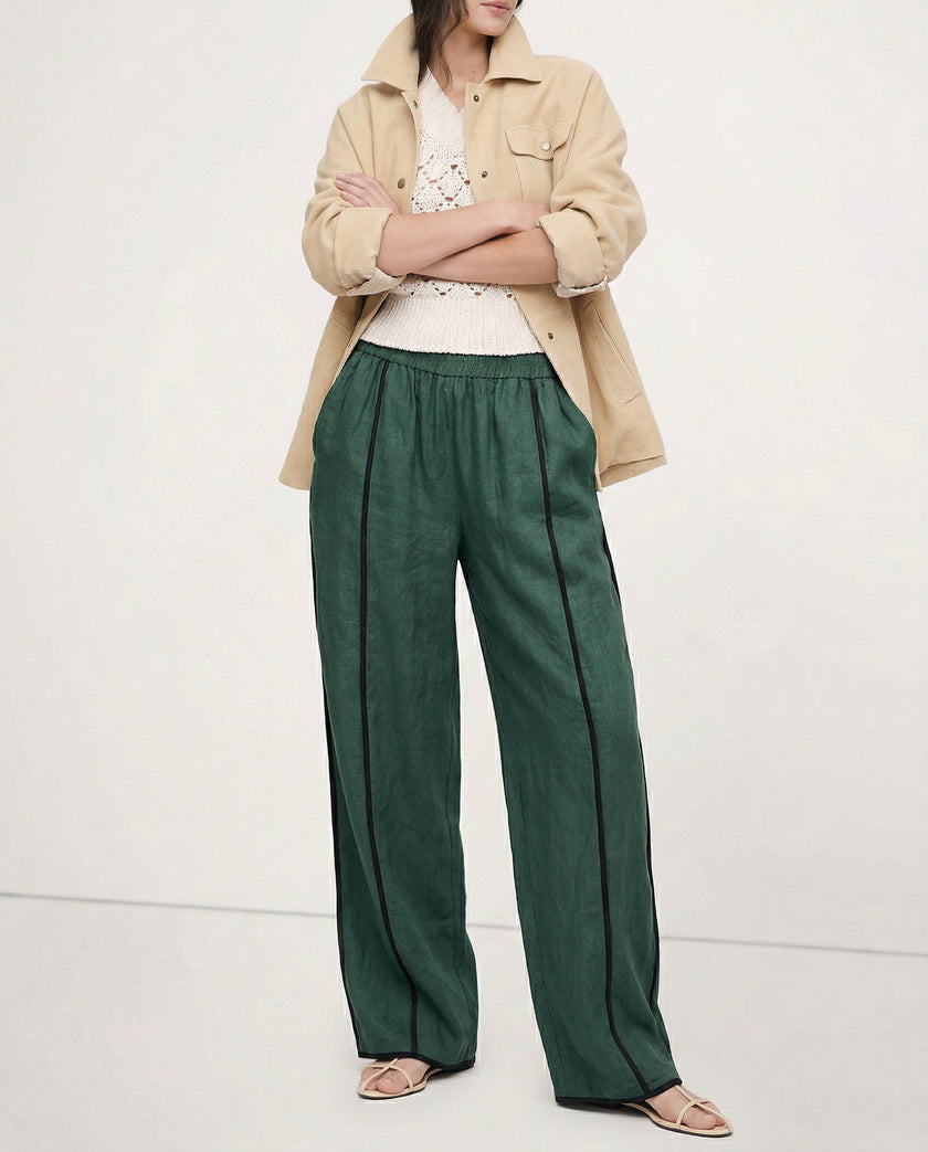 Women’s linen wide-leg trousers with elastic waist from FJØRNA, showcasing high-quality, realistic linen fabric and relaxed fit.