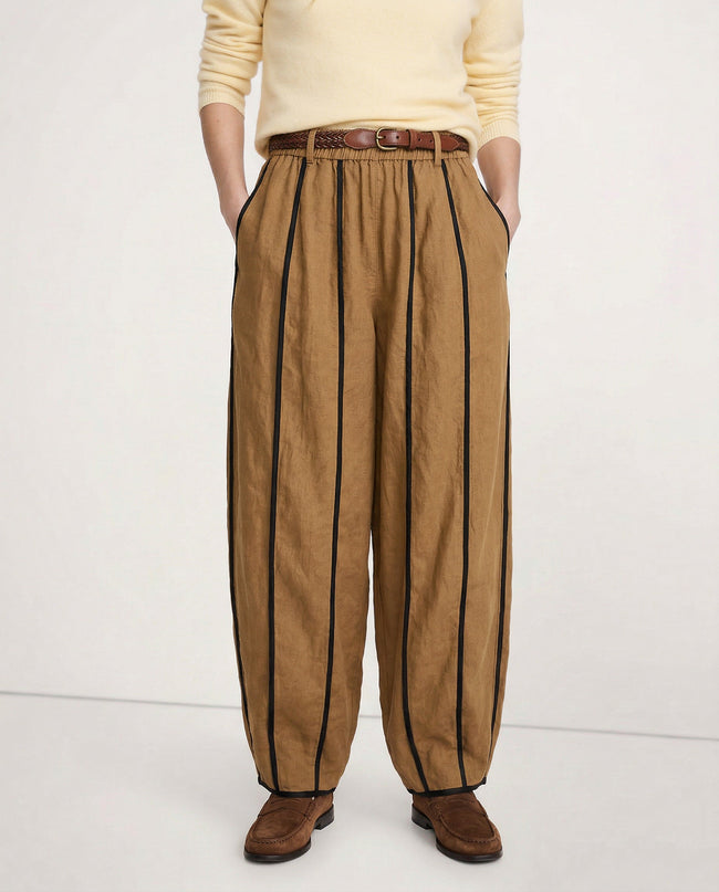 FJØRNA linen wide-leg trousers for women with elastic waist, showcasing high-quality, realistic linen fabric in a natural pose.