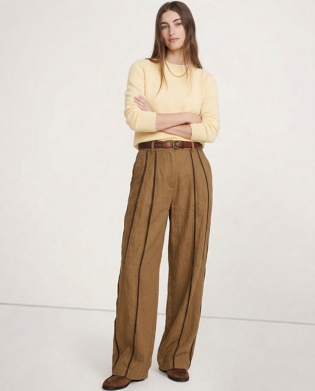 FJØRNA linen wide-leg women's trousers with elastic waistband, showcasing soft, high-quality linen fabric and relaxed fit.