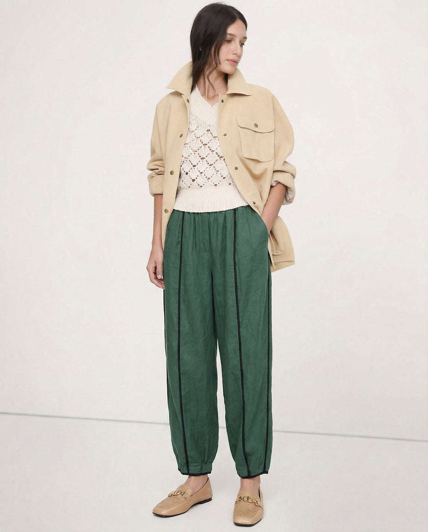 FJØRNA linen wide-leg women's trousers with elastic waist, showcasing quality linen fabric and relaxed fit in a realistic style.