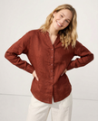 FJØRNA women’s linen V-neck shirt, lightweight and breathable, shown on a model with a relaxed fit and natural fabric texture.