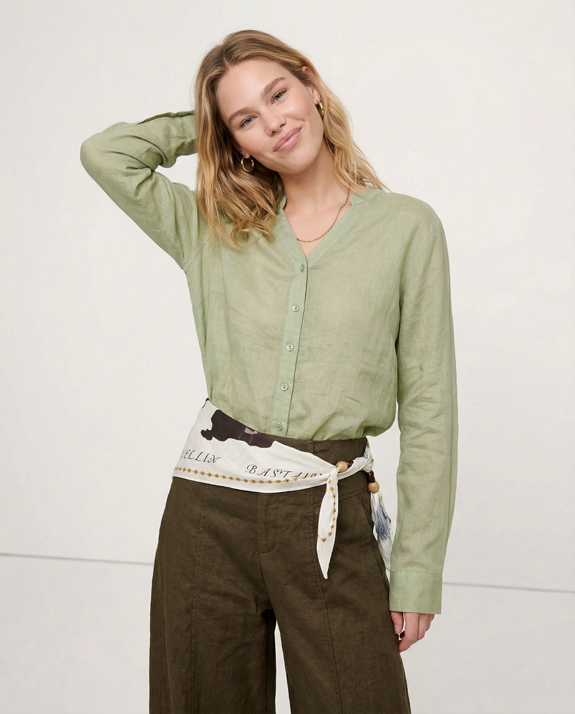 Women’s linen V-neck shirt by FJØRNA, featuring a relaxed fit and light fabric, shown on a model wearing casual summer tops.