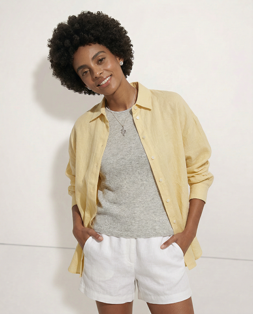 FJØRNA linen shirt with slit hem detail worn by model, showcasing lightweight fabric and relaxed fit.