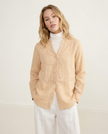 Women’s linen V-neck shirt by FJØRNA, shown in natural beige, lightweight, relaxed fit, casual top for warm weather.